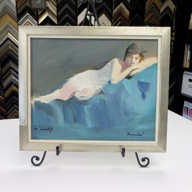 a handmade painting framed in silver