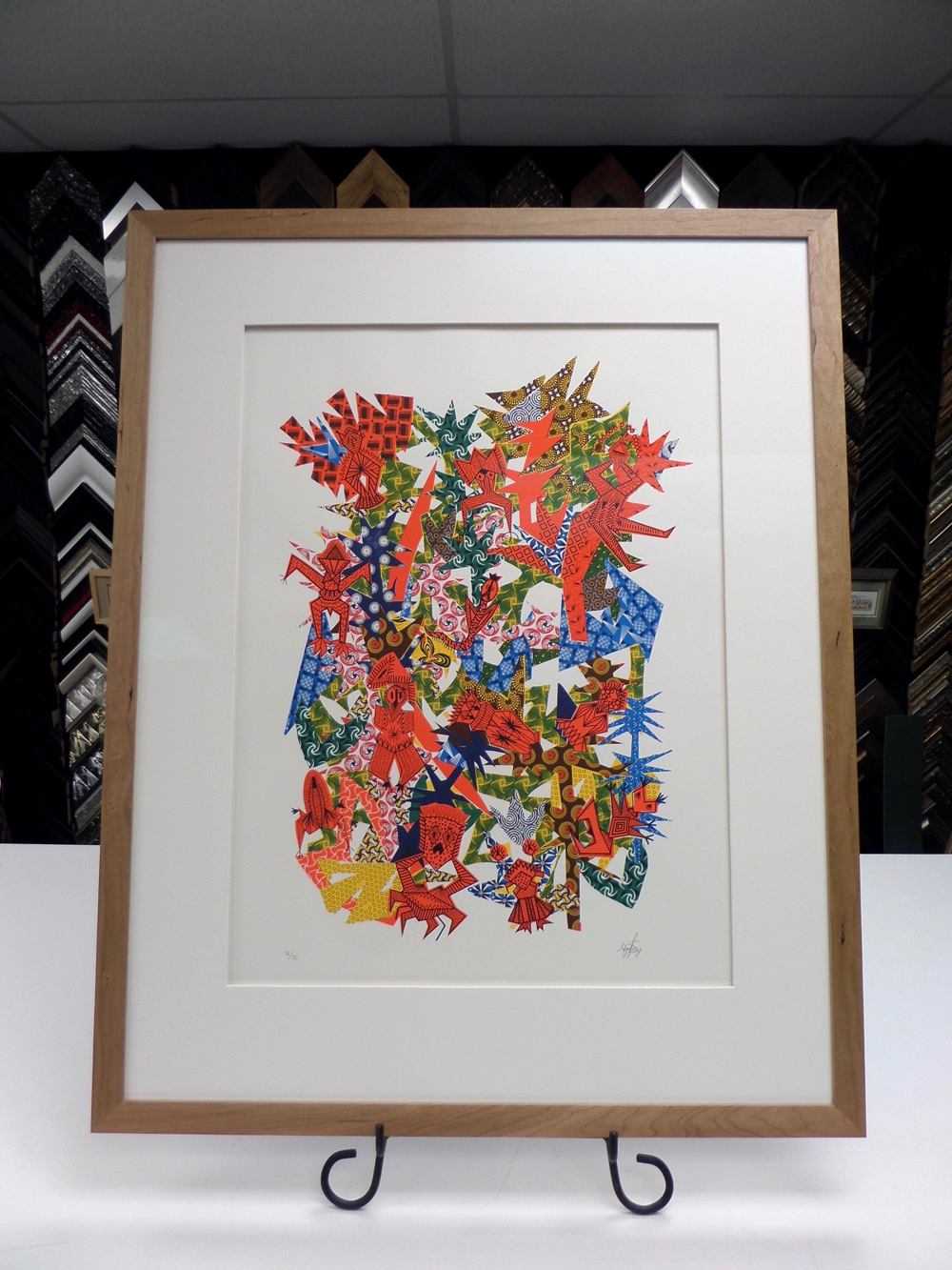view of a colourful picture framed in white and brown combination