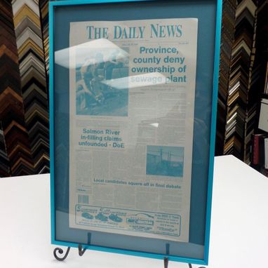 a newspaper page custom framed